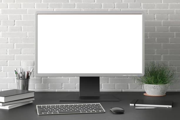 istock Workspace with blank computer monitor screen mock up. 1204299485