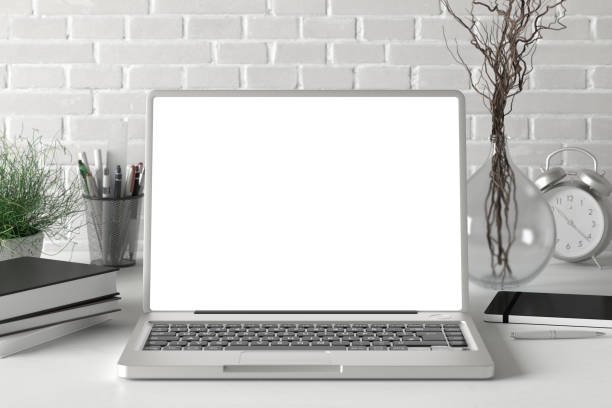 istock Workspace with blank laptop monitor 1204299539