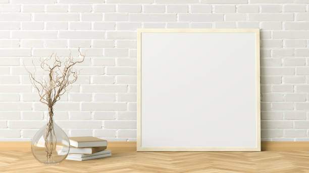 istock Blank poster frame mock up standing on the floor next to wall 1204299641