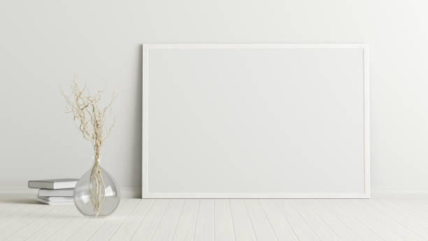 istock Blank poster frame mock up standing on the floor next to wall 1204299697