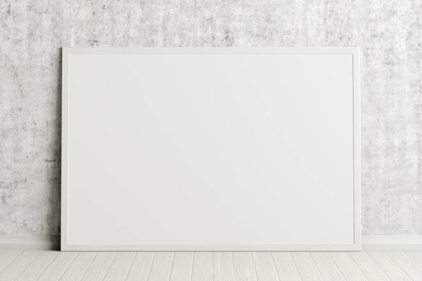 istock Blank poster frame mock up standing on the floor next to wall 1204299701