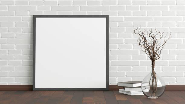 istock Blank poster frame mock up standing on the floor next to wall 1204299723