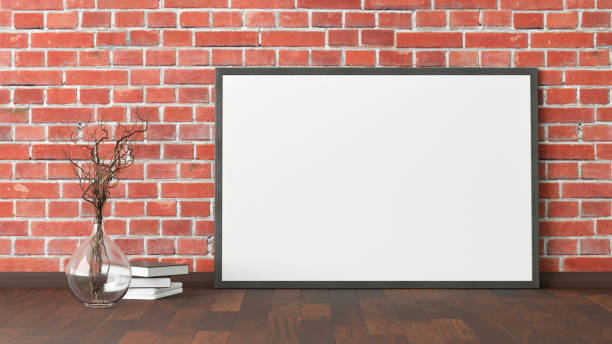 istock Blank poster frame mock up standing on the floor next to wall 1204300276