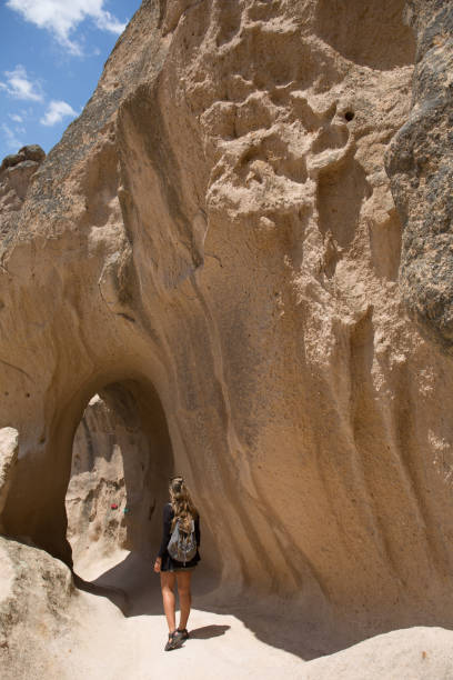 istock Young woman explores caves in Cappadocia 1204301333