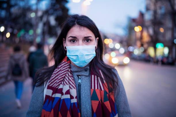 Portrait Of Woman With Face Mask. Close up portrait of Latino young woman on the street, she walking on the street with protective face mask and looking at camera, she looking sick and scared. avian flu virus photos stock pictures, royalty-free photos & images