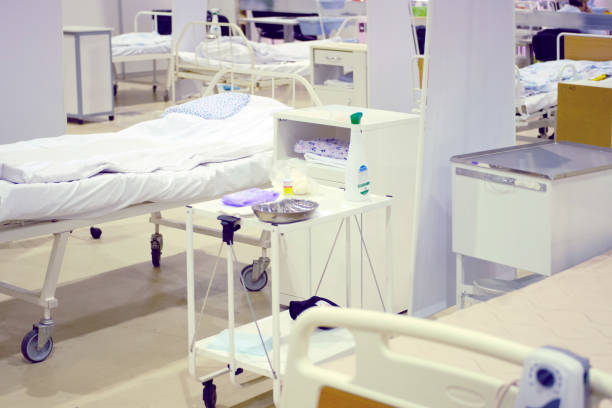 istock Empty beds in the hospital's open space ward 1204304106
