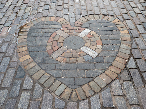 The Heart of Midlothian, a heart shaped pattern of cobblestones in the Royal Mile, Edinburgh, Scotland.
It is considered good luck to spit onto the stone when passing by.