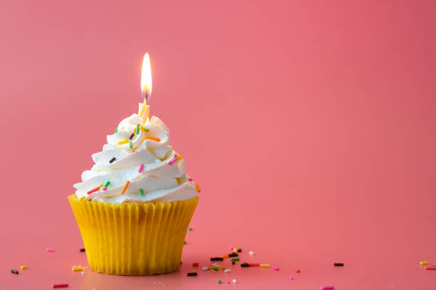 istock Homemade Birthday cupcake on pink Background. 1204305385