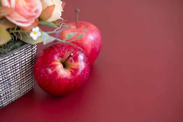 Two red gala apples on mahogany background. Closeup macro view.