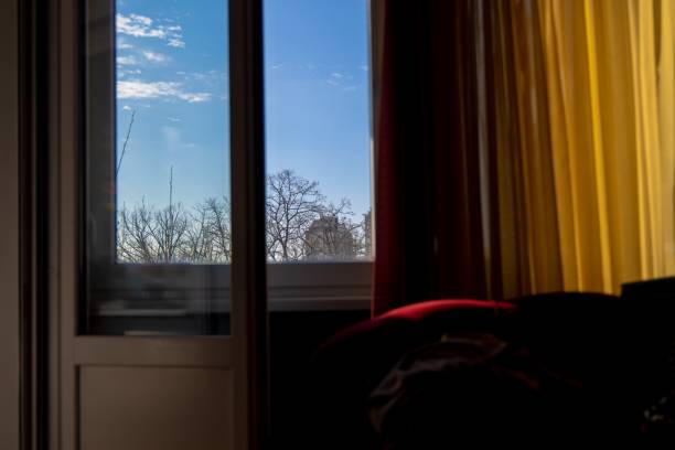 istock Afternoon sun on beautiful blue sky and clouds from inside the room 1204312217