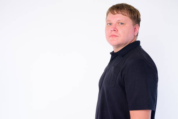 istock Profile view of overweight man looking at camera 1204312419