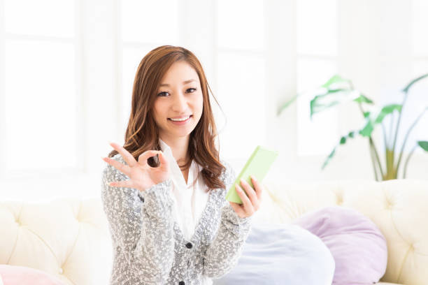 istock asian woman to see a smart phone 1204314163