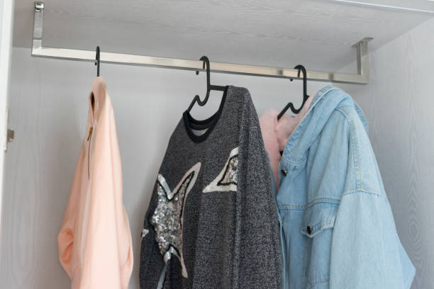 istock Stylish clothes in wardrobe closet 1204327875