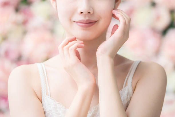 japanese woman beauty image pale pink flower background body care and beauty stock pictures, royalty-free photos & images