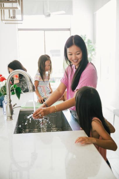 istock Mom and kids in the kitchen together. 1204329144