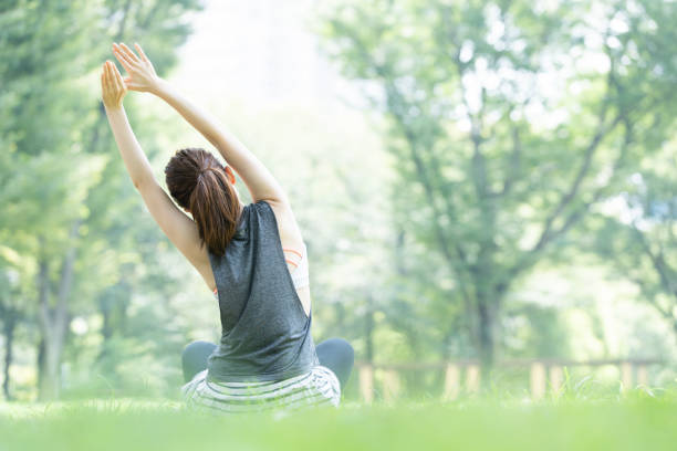 istock yoga poses at the park 1204329881