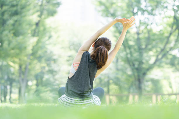 yoga poses at the park japanese woman forest bathing photos stock pictures, royalty-free photos & images