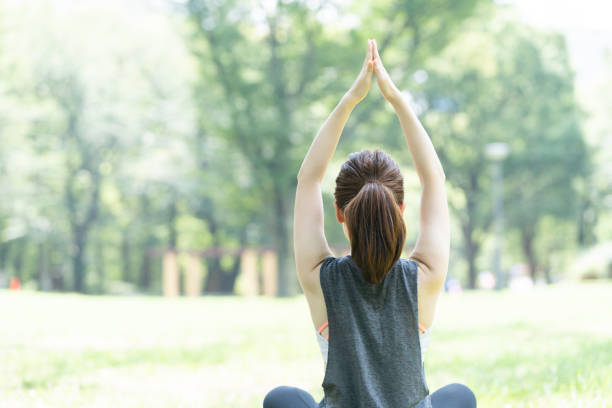 istock yoga poses at the park 1204329914