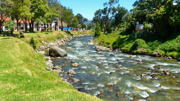 Cuenca, Ecuador.  View of the river Tomebamba and public park along the river that crosses the center city of Cuenca.