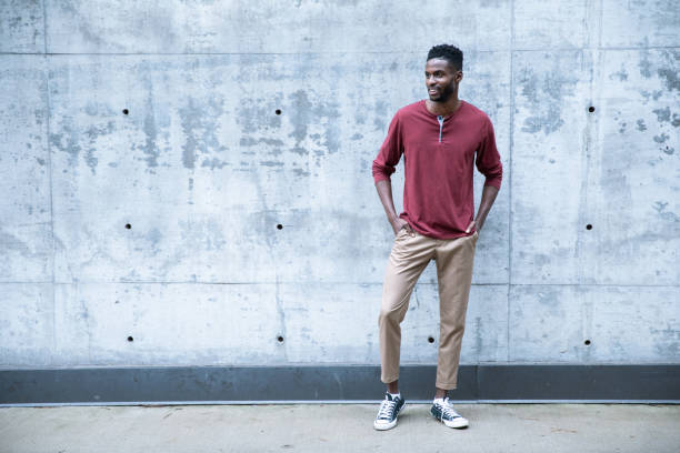 istock Cheerful Black Male Standing by a Concrete Wall 1204334558
