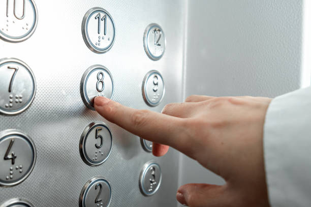 istock Female hand, finger presses the elevator button. up the career ladder. 1204335397