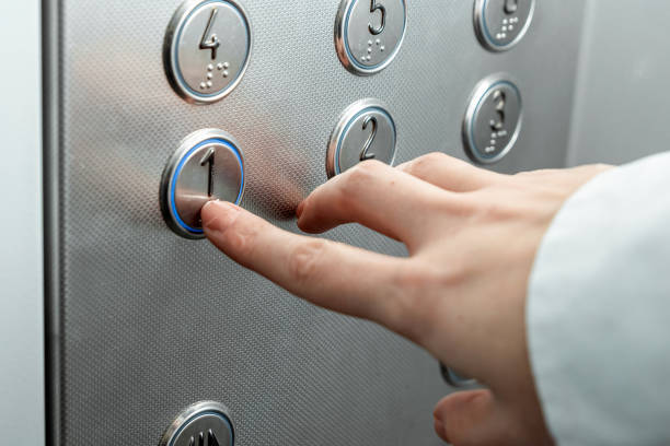 istock Female hand, finger presses the elevator button. up the career ladder. 1204335399