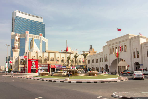 street view of Manama, the capital city of Bahrain Street scene in the Customs Square in central business district of Manama, Bahrain, with the historical Bab Al Bahrain, the ancient gateway to the city of The Persian Gulf manama stock pictures, royalty-free photos & images