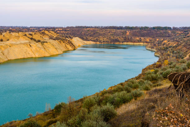 istock Lake with sandy bank in the abandoned coal quarry 1204338399