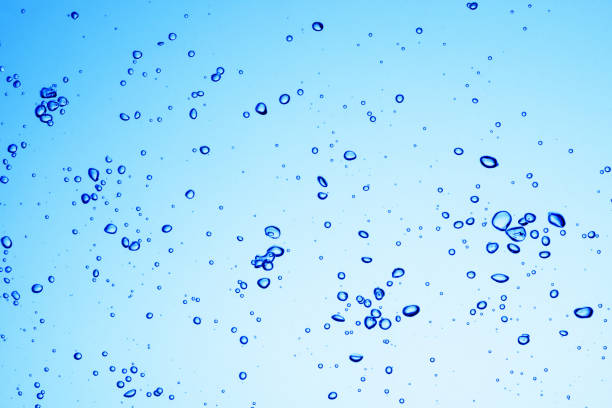 istock Bubbles of air under blue water background 1204340695