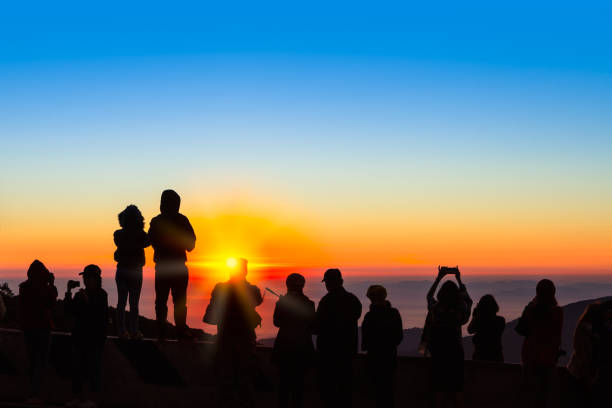 istock Silhouetted of people with sunrise 1204343750