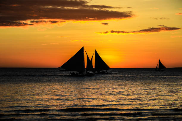 istock Philippines Boracay White Beach Sunset sailing 1204346453