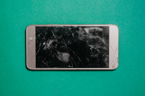 istock broken smartphone screen. Three-dimensional photo of broken equipment on a single-color blue mint background, top view 1204349394