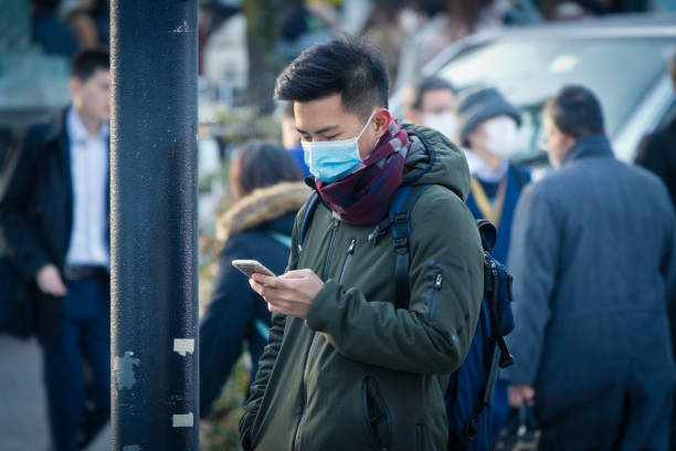 istock Man wearing mask on the street 1204349427