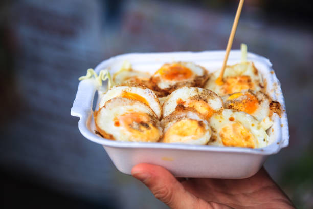 istock Selective Focused Cooked Quail Eggs Sprinkled with Seasoning in White Foam Box. Traditional Thai Street Comfort Food, Asian Cuisine, Delicacy, Culture, Cooking, Snack, Indulgence and Nutrition concept 1204354871