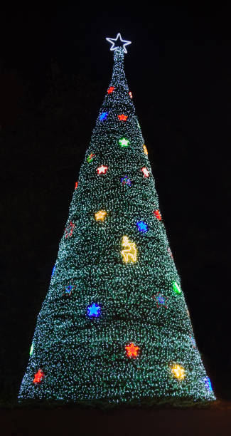 istock Glittering Glowing Sparkling defocused Night Light (bokeh) Illumination background with decorated Christmas Tree. Special Holidays, Festival design decoration, New Year Celebration, Party concept 1204354938