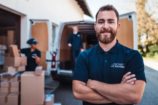 Photo of Portrait of a man standing in front of delivery van