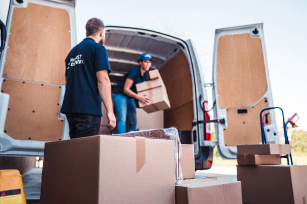 istock Coworkers rushing to load packages in a delivery van 1204355670