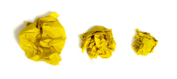 istock Yellow Crumpled Paper Balls Isolated on White Background 1204357783