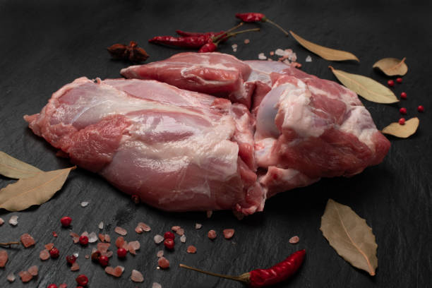 Fresh raw beef steak on black stone background