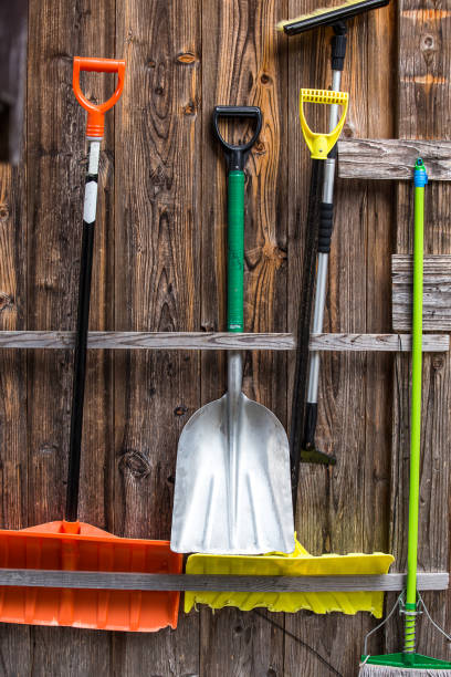 istock shovel on wooden wall background. 1204359479