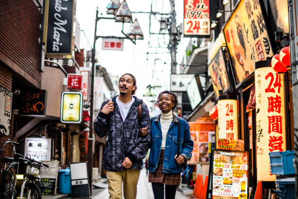 istock Young couple exploring back street in Tokyo 1204359697