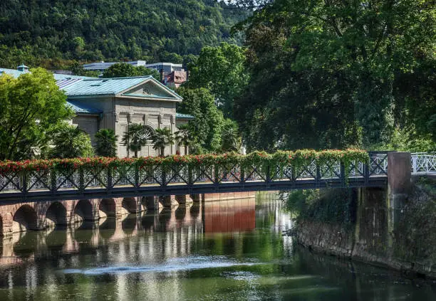 A beautiful sunny view of the “Fränkische Saale” river running through Bad Kissingen, Germany – with its world famous thermal baths and spas.