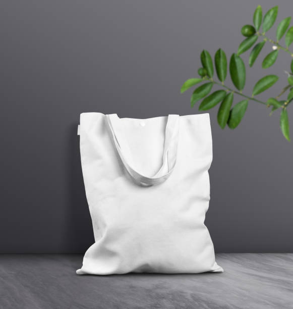 White tote bag against dark grey background Beautiful scene of white blank empty tote bag on marble floor pakistan photos stock pictures, royalty-free photos & images