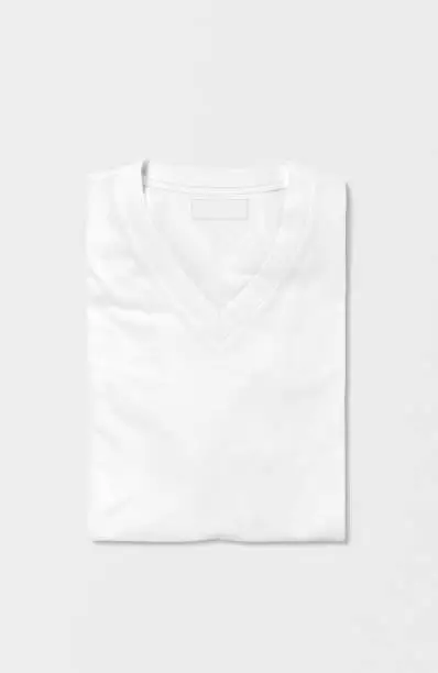 White blank folded v neck t shirt on isolated background
