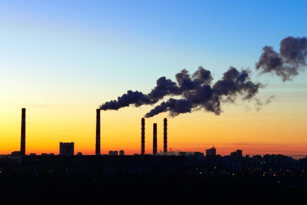 istock pipes smoke factories at sunset 1204361618