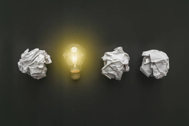 istock Cumpled paper on the blackboard turned into a light bulb. New idea concept 1204362814