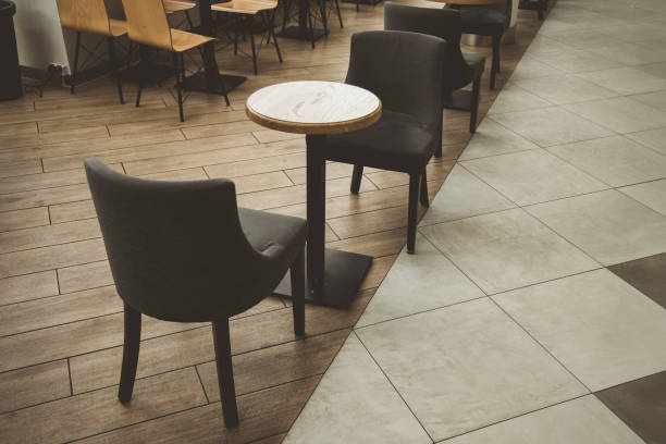 istock cafe interior in shopping mall indoor environment small table and two empty chairs on tile floor without people here 1204365512