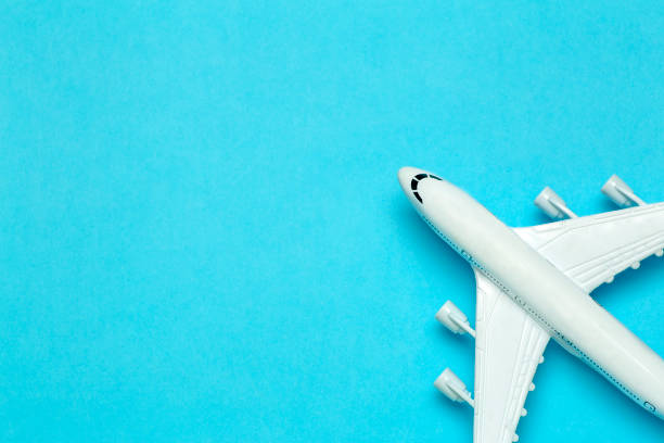 istock Travel minimal background. Model airplane in flight on an empty colored background. Copy space 1204365794