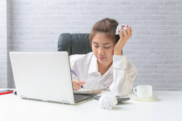 Serious asian business woman working on laptop at office. Serious asian business woman working on laptop at office. angry general manager stock pictures, royalty-free photos & images