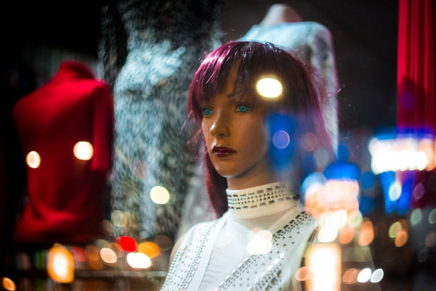mannequins in shop window at night